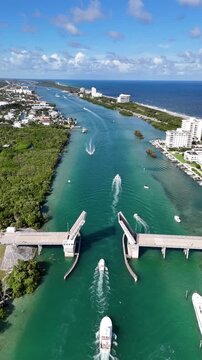 Boats in the intracoastal passing through a drawbridge opening near Jupiter Inlet in Palm Beach County, Florida. 