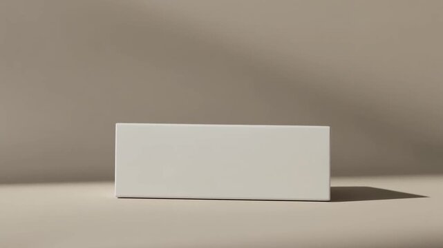 Minimalist white blank box packaging on a neutral background with soft shadows and elegant slow zoom.
