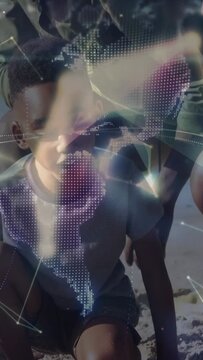 Vertical video: Child digging with pink shovel by sea, adult showing shell, tech globe appearing