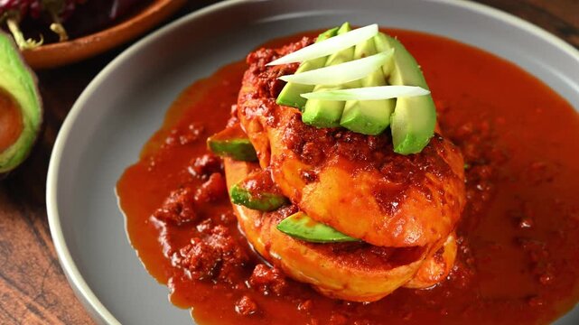 Traditional Mexican lunch, pambazo bathed in red adobo sauce