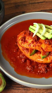 Mexican food, Traditional Mexican lunch, pambazo bathed in red adobo sauce
