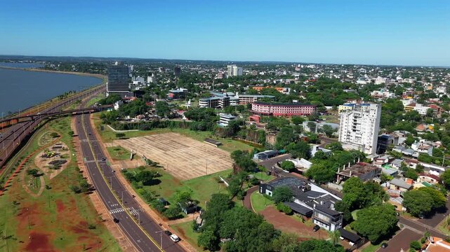 Parque La Cantera in Posadas Misiones Argentina, and the Hospital Escuela de Agudos Dr Ram&oacute;n Madariaga within the city landscape, drone push in revealing surrounding green spaces and nearby districts