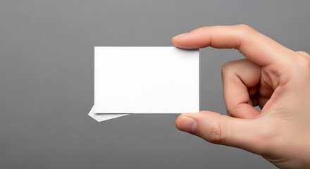 Obraz premium Hand holding blank white business cards against grey background