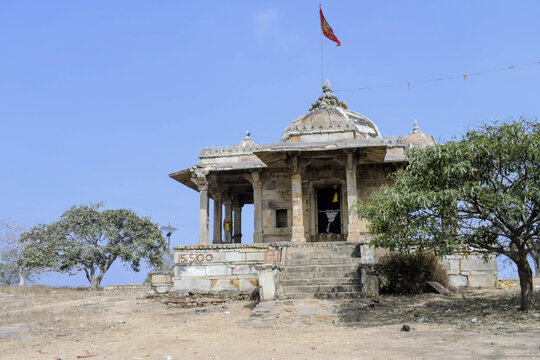 high-angle view of the medieval parvati shrine, showing its domed roofs, red flag, and intricate stone carvings overlooking the rugged kaimur hillside