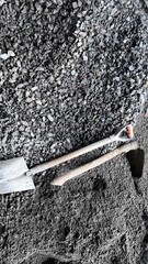 Rugged Shovels Resting on Gravel and Dirt at Construction Site