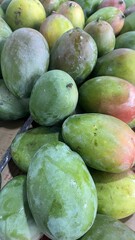 Fresh Green Mangoes Piled High in Market Display
