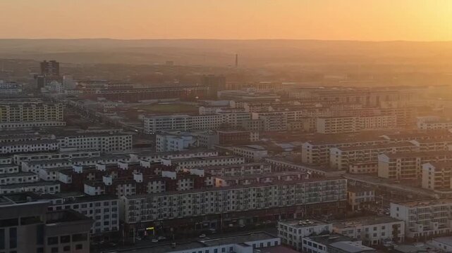 Horizontal aerial shot looking down at a vast expanse of densely packed rooftops and houses in an old Chinese county. Showcasing the authentic urban fabric, narrow alleys, and local lifestyle of a tra