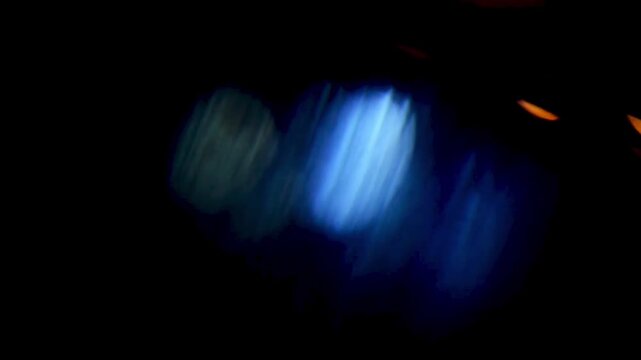 Abstract, Shifting Glare and Light Transitions with Bokeh Effect on Black Background