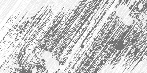 Obraz premium Abstract background with diagonal gray brush strokes and scattered dark particles on a white surface.