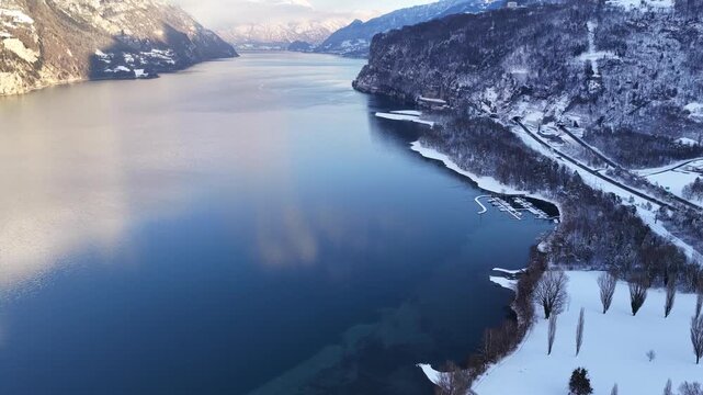 Aerial view of Walensee&rsquo;s snowy banks and icy coves near Walenstadt, Amden, and Quinten. Switzerland