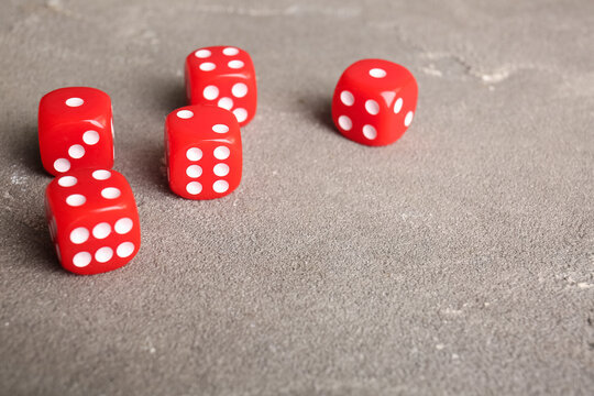Red dices on grey background