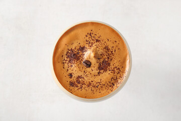 Glass of tasty espresso martini cocktail on white background, closeup