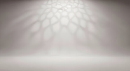 Empty light gray studio backdrop with projected Islamic geometri