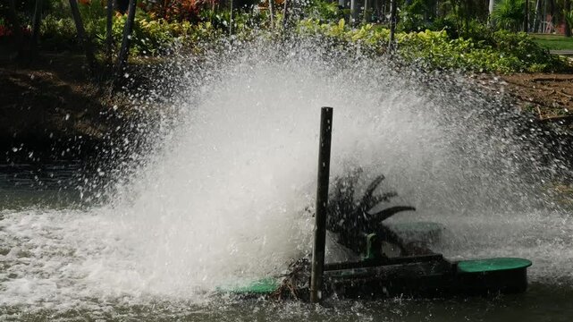 Water aerator turbine fountain creating massive spray for oxygen circulation and wastewater treatment in urban park pond