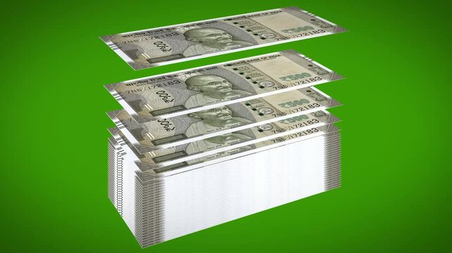 500 Indian Rupee notes stacking on top of each other one by one to form a tall pile against a green background.