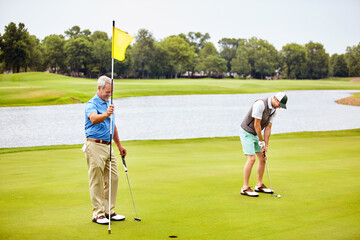 Obraz premium Sport, flag and fitness with friends on golf course for hole in one, competition training and score. Game target, tournament goal and golfer club with men outdoor for hobby, challenge and match