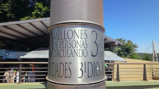 Pillar with engraved text highlights key facts about the tri border region at Hito Tres Fronteras in Puerto Iguaz&uacute;, Argentina.
