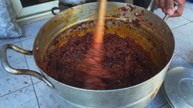 Mixing and blending the Berbere red chilly powder outdoor in Ethiopia Addis Ababa