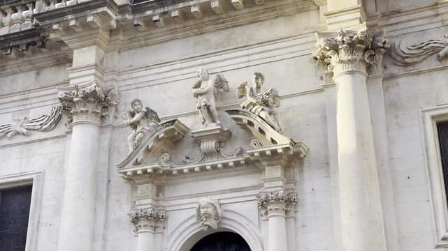 Cinematic view of the front facade of St Blaise's Church in Dubrovnik Old Town captured in the early morning at sunrise [travel b-roll]