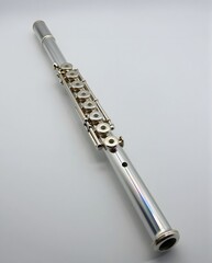 Beautiful Silver Flute Musical Instrument with Intricate Key Design on a Clean Background