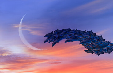 Group of dolphins jumping up from the sea Crescent moon in the background amazing sunset