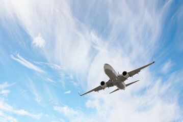 White passenger airplane flying in the sky amazing clouds in the background - An airplane shakes during turbulence flying air hole - A plane spinning in round clouds - Front view of an airplane 