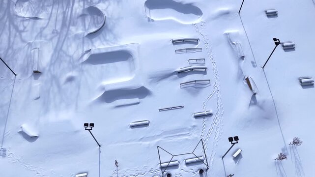 Outdoor public park in Winter time after deep snow fall from freezing cold front in central New York State village of Fairport