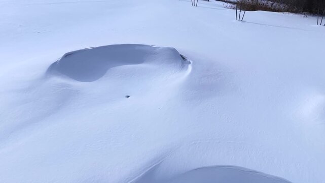 Outdoor public park in Winter time after deep snow fall from freezing cold front in central New York State village of Fairport