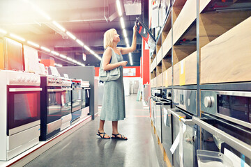 Woman chooses kitchen oven