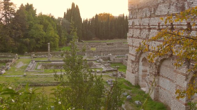 A sweeping view of the archaeological site of Cemenelum in Nice, France, showcasing the well-preserved ruins of the Roman Baths. The footage highlights the ancient stone and brick masonry of the therm