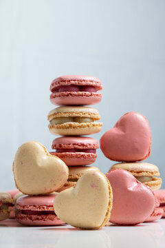 Colorful Heart-Shaped and Round Macaron Cookies Piled up in a Creative Display