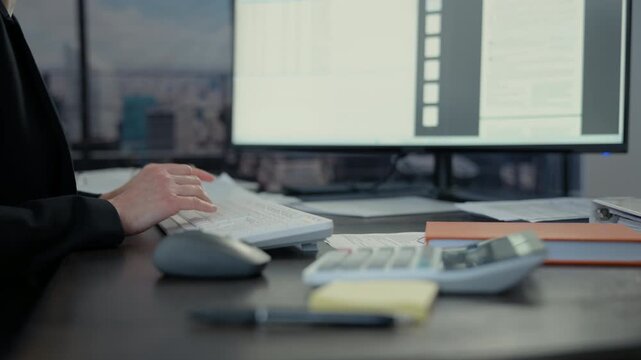 Close up shot of business woman accountant making calculations financial data sheet with calculator. Business and financial concept.