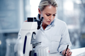Fototapeta premium Notes, woman and scientist with microscope for test results, development or medical innovation. Mature person, science lab and writing info with microbiology equipment for research, study and report