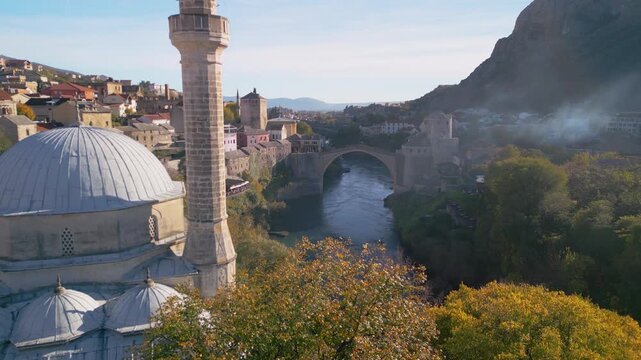 Epic 4K aerial panorama of Mostar Old Town and Stari Most bridge, UNESCO heritage site over turquoise Neretva river, Bosnia and Herzegovina, cinematic cityscape