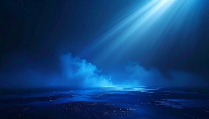 Mysterious blue light beam shining down on foggy horizon with starry sky background