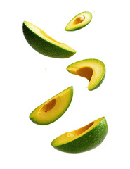 Sliced avocado pieces falling on black background, showcasing texture and color
