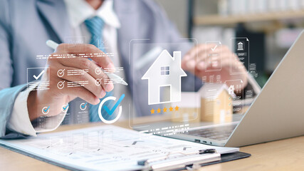 Businessman using laptop with digital real estate management interface, smart home evaluation, property investment, mortgage approval, online documentation and housing technology concept.