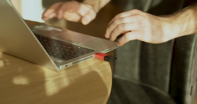 Practical stock footage showing hands trying to plug a USB stick into a laptop, highlighting a technical problem where the device is not recognized, symbolizing data access issues, hardware failure, a
