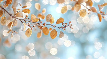Obraz premium Golden leaves on branch with soft bokeh background create serene and calming atmosphere. gentle glow enhances beauty of nature