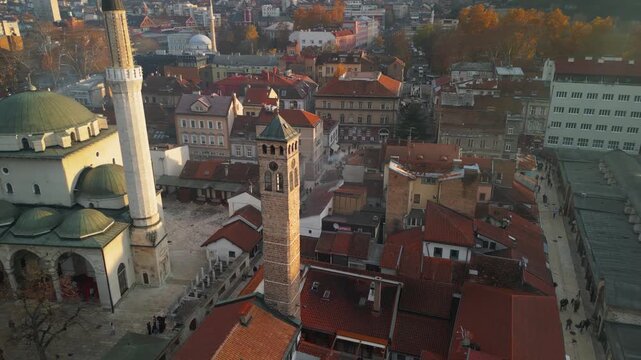 Aerial view of the historic Ottoman Clock Tower Sahat-kula and Gazi Husrev-beg Mosque in Sarajevo old town Bascarsija, Bosnia and Herzegovina travel, 4k drone