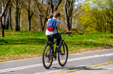 Naklejka premium Cyclist ride on the bike path in the city Park 