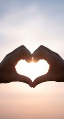Fototapeta premium Hands forming heart shape against sunset sky with sunlight 