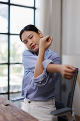 Body muscles stiff problem, ache asian young woman pain neck and shoulder while sitting work on...