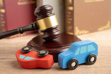 Car accident lawsuit and insurance, Judge hammer with car model.