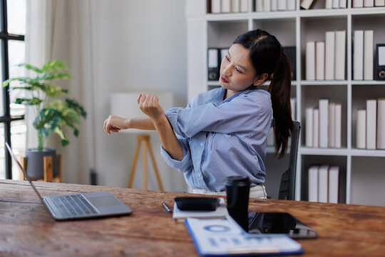 Body muscles stiff problem, ache asian young woman pain neck and shoulder while sitting work on chair at home, male holding massaging rubbing, hurt or sore body. Healthcare people, office syndrome.
