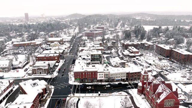 Amherst City Center in Massachusetts USA on snowy winter day, aerial establish