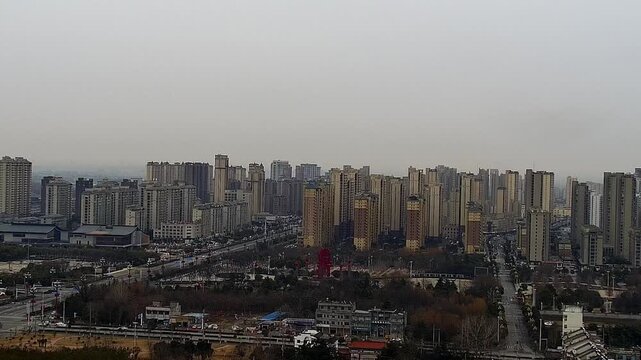 A cinematic horizontal aerial shot from a fixed position, overlooking a cluster of modern skyscrapers in a Chinese financial district. Featuring sleek glass facades, intricate architectural details, a