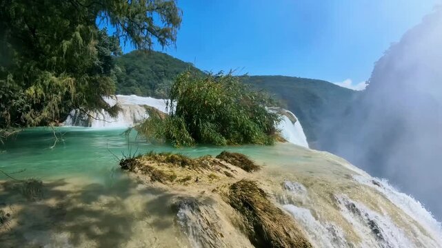 Explore Cascada de Tamul in Huasteca Potosina San Luis Potosi Mexico with lush vegetation and flowing water