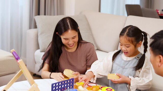 Asian Family Playing and Learning Together With Educational Toys