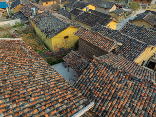Close aerial view of weathered tile roofs in traditional village.
